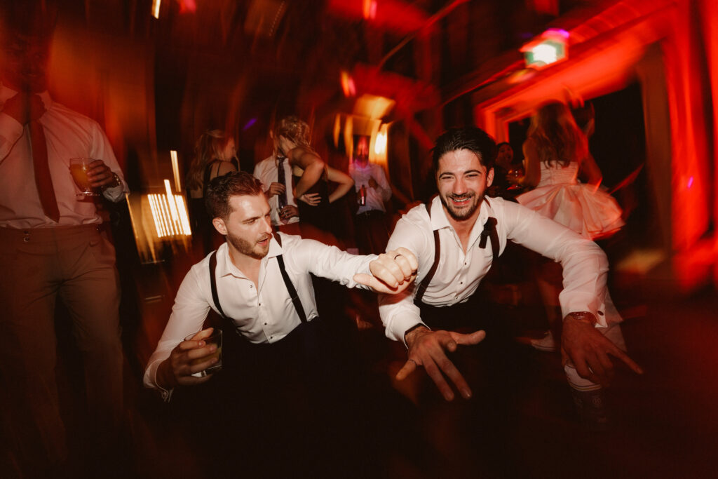 The groomsmen getting dirty and low at the Barns at Cave Spring Vineyard