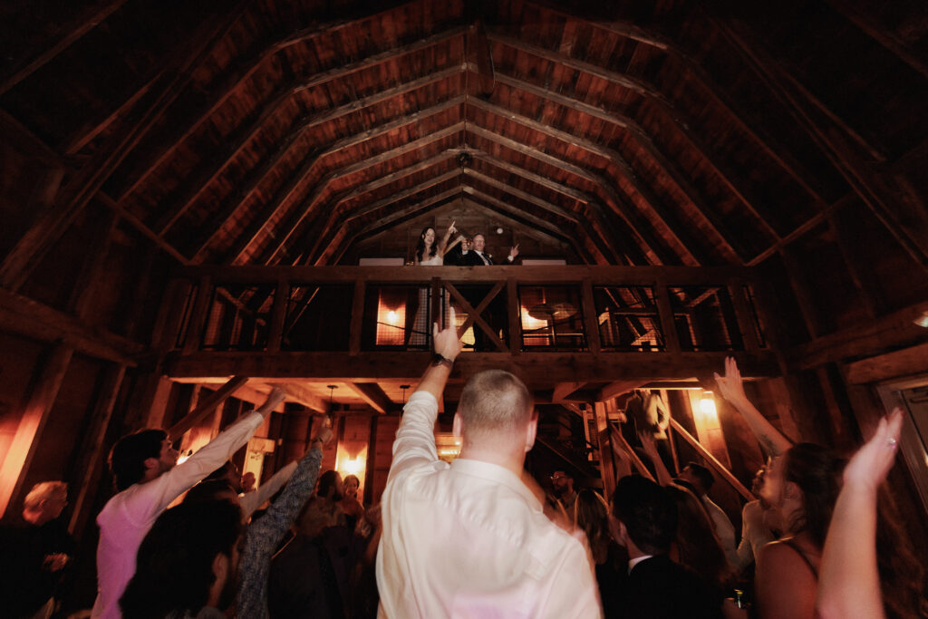 Bride & Groom on the upper balcony at Cave Spring Vineyard Barns